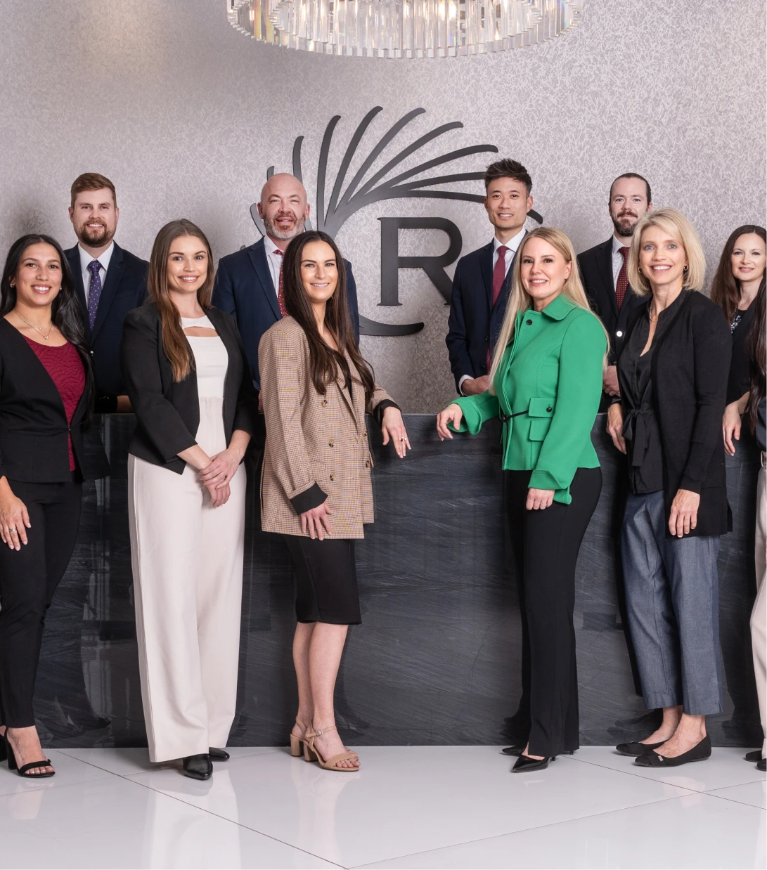 Regency Specialties team of ten professionals posing together in front of the practice logo